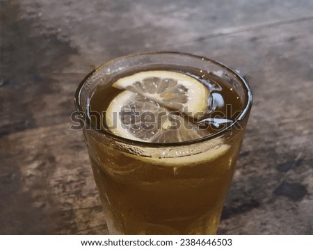 This is a glass of lemonade with slice of lemon on the top