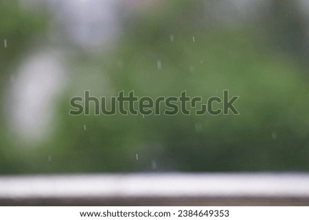 Rain drops of rain falling from a window