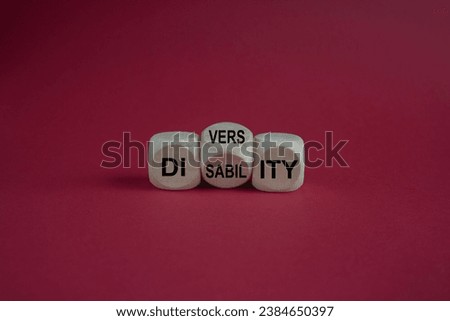 Diversity or disability symbol. Concept words Diversity disability on wooden cubes. Beautiful red background. Business diversity disability concept. Copy space.