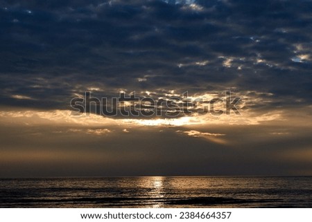The rays of the sun shine through the clouds. Colorful cloudy sky at sunset. Gradient color. Sky texture, abstract nature background. Positive photography.