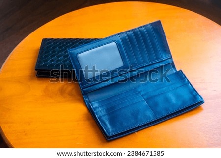 Leather wallet, removable and can hold cards, placed on a wooden table, photos, sets, promotional items.