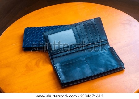 Leather wallet, removable and can hold cards, placed on a wooden table, photos, sets, promotional items.