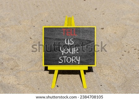 Tell us your story symbol. Concept word Tell us your story on beautiful black chalk blackboard. Beautiful sand beach background. Business tell us your story concept. Copy space.