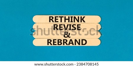 Rethink revise rebrand symbol. Concept word Rethink Revise and Rebrand on beautiful wooden stick. Beautiful blue background. Business brand motivational rethink revise rebrand concept. Copy space