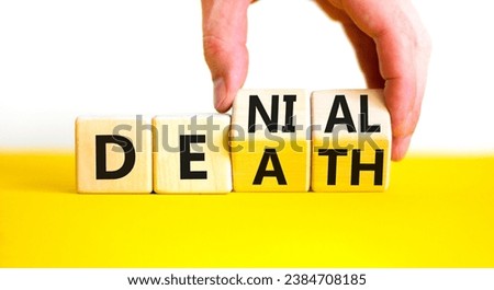 Denial death symbol. Concept words Denial Death on wooden block. Beautiful yellow table white background. Businessman hand. Business denial death concept. Copy space.