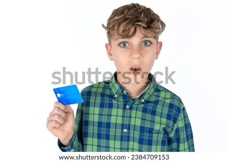 Photo of Handsome Caucasian teenager boy amazed shocked hold credit card payment