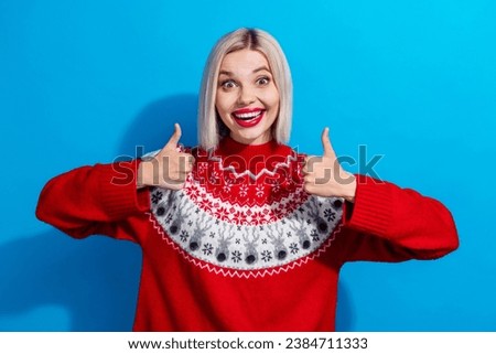 Portrait of astonished attractive lady beaming smile demonstrate thumb up approval isolated on blue color background