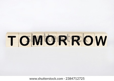 Tomorrow word written on wood blocks on desk