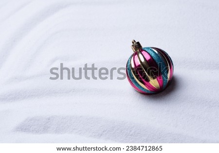 Colorful  Christmas balls on abstract cold winter background with snow
