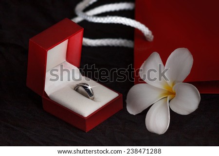 Beautiful diamond ring in a gift box on black background with copy space.  Macro with shallow dof.