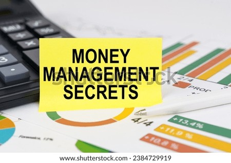 Business concept. On business reports there is a calculator and a sign with the inscription - Money Management Secrets