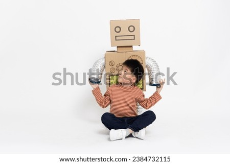 Asian little boy sitting with toy robot paper diy isolated on white background, Artificial intelligence by toy and new innovation technology inspiration concept
