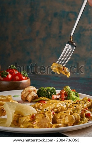 A dish of chicken meat cooked with mushroom cream with appetizers