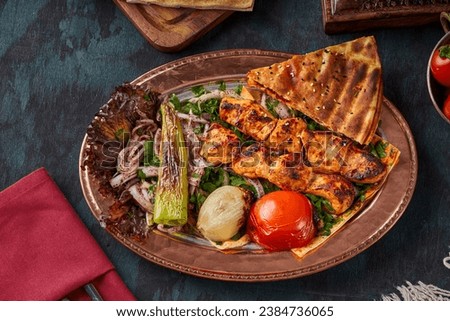 Grilled chicken breast dish with appetizers