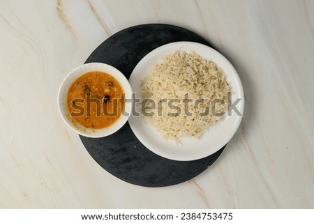 Indian Traditional Cuisine Dal Fry or Rice Also Know as Dal Chawal, Daal Chawal, Dal Rice, Whole Yellow Lentil with Rice or Dal Tadka, Daal Fry Served with Rice Royalty-Free Stock Photo #2384753475