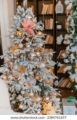 Christmas office with bookshelves with a sofa, Christmas tree with toys. Interior decoration for the holiday. present. Home comfort