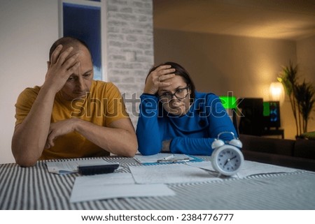 Couple upset headache depressed from family cost got higher  holding receipts from supermarket with calculator by rising grocery prices and surging cost as an inflation financial crisis. Royalty-Free Stock Photo #2384776777