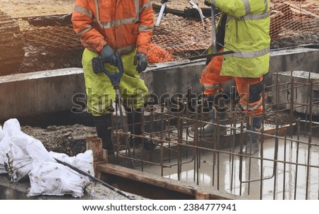 Concrete cast-in-place work. Builder level wet concrete. Concrete works on buildiiing construction site Royalty-Free Stock Photo #2384777941