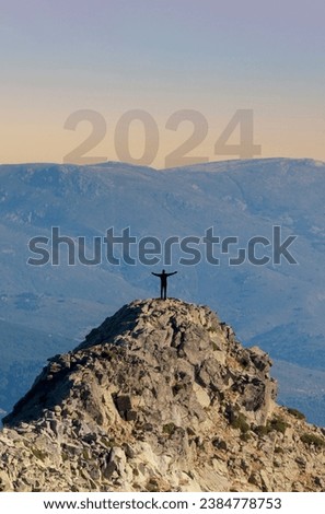 Start of new year 2024, Happy new year. Silhouette of a man, challenge of personal improvement. Climb a mountain, climb with hope