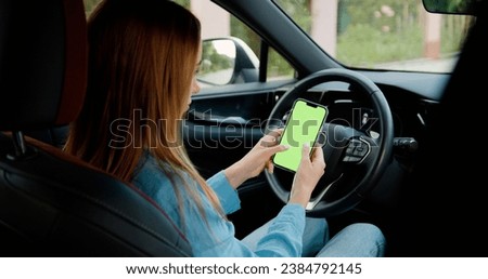 Young woman hands using smartphone with vertical green screen in modern car chroma key smartphone technology cell phone street touch message display hand.