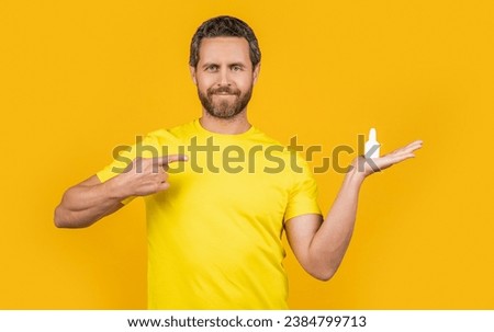 man with nasal medicine in studio, point finger. photo of man with nasal medicine drops. Royalty-Free Stock Photo #2384799713