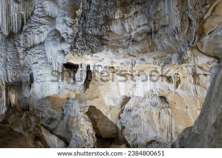 Lime stone stalactites in the cave - mineral formation that hangs from the cave's ceiling - Europe France