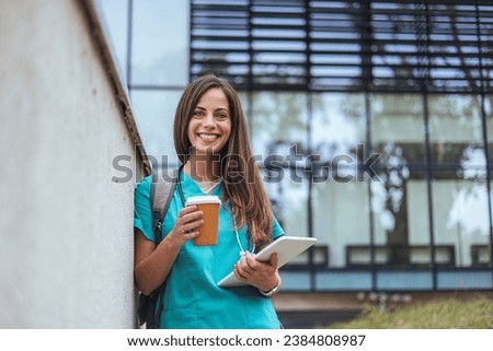 Representation of the daily life of a nurse going to work. Young, confident nurse outside looking away with smile on her face. Nursing or medical student walking to class on hospital campus