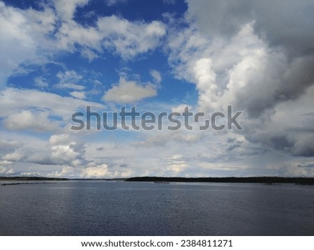The landscape of a wide river with a stunning sky in summer in gorgeous weather