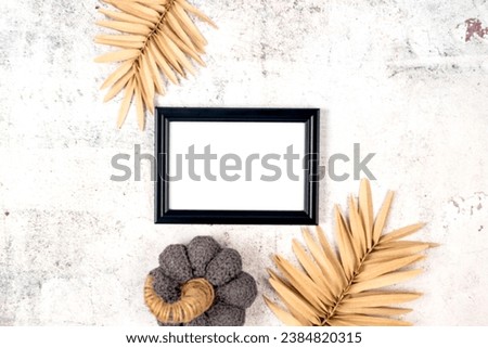 Picture frame mockup with decorative pumpkin on grey concrete background, Thanksgiving, Halloween holiday poster concept.