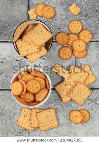 Dry French cracker with sesame seeds on concrete background.Homemade gluten free chocolate chip and nut cookies,modern bakery concept. Healthy breakfast with ingredients, top view, selective focus,