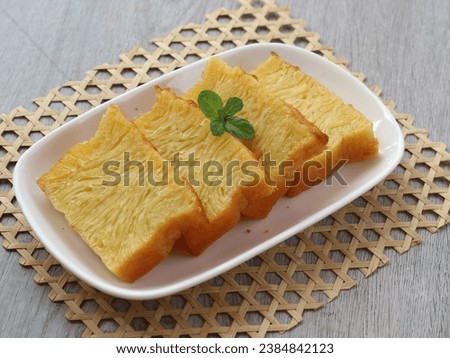 Kue bika Ambon or kuih bingka Ambon or kueh bengka Ambon is cake from Medan, Indonesia. Its made with tapioca starch, egg and coconut milk with honeycomb texture. served on plate. selected focus Royalty-Free Stock Photo #2384842123