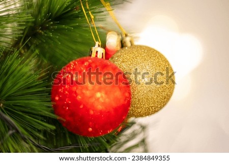 Christmas Tree with Decorations and Gift box Near window with Light. Decorative colorful christmas balls on pine tree with bokeh background, shallow depth of field, new year decor, merry christmas