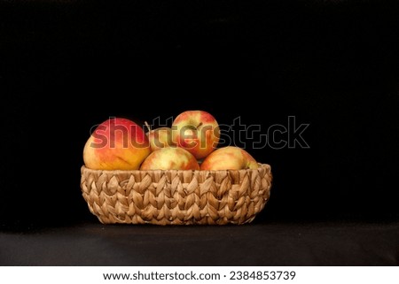 a group of apples sitting on top of a wooden stand on a black background with a black background behind them,  detailed product photo, a still life, precisionism
