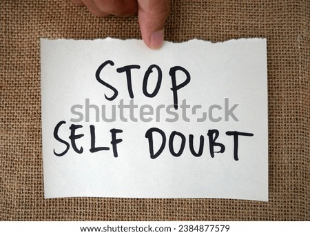 Handwritten message paper STOP SELF DOUBT, concept of self worth , stop striving for approval, more valid , more loved or validation , you are good enough Royalty-Free Stock Photo #2384877579