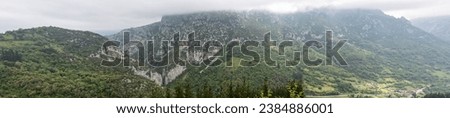 Incredible mountains covered by clouds in Asturias. Mountainous landscape with abundant vegetation. Panoramic photography.