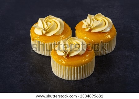 cupcake with cream on grey cement background. with clipping path