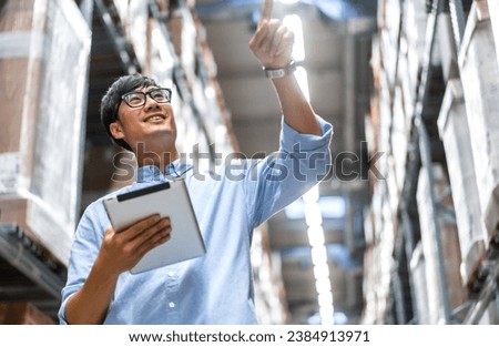 Portrait engineer worker labor asian man shipping order detail check goods and supplies on shelves with goods background inventory in factory warehouse.logistic industry and business export