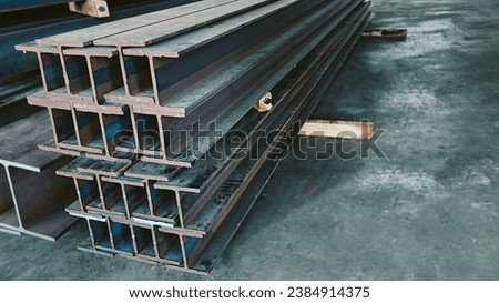 Steel beams production. Metal girders stack on project construction , steel h-beam, selective focus, Raw materials used in building construction. Royalty-Free Stock Photo #2384914375