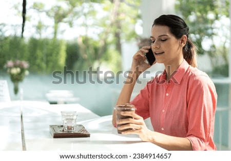Portrait of smiling happy cheerful beauty pretty woman relaxing looking at camara and drinking cup of hot coffee or tea.Girl felling enjoy having breakfast in holiday morning vacation at cafe