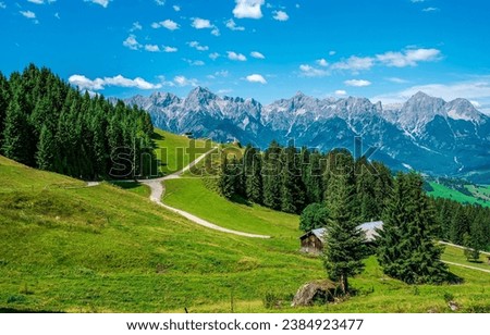 A mountain village on the Alpine hills. Alpine village in mountains. Alpine farm in mountains. Mountain village in Alps Royalty-Free Stock Photo #2384923477