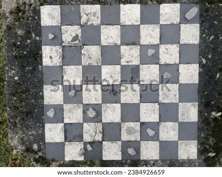 Aged chessboard with dirty surface and stones