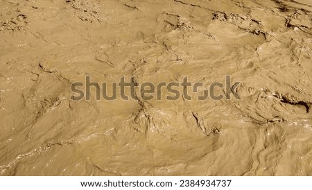 Muddy Dirty flood Water rapidly Flowing in River after heavy rain storm in the valley|brown mud colour Pattern and background HD|Ultra High resolution picture|stock photography images for desktop