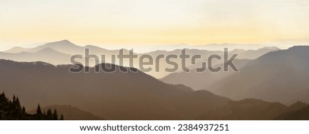 Mountain range with visible silhouettes through the  colorful fog. Abstract landscape. Freedom and active lifestyle concept. Vibrant photo wallpape. Natural background. Panorama, Carpathian, Ukraine