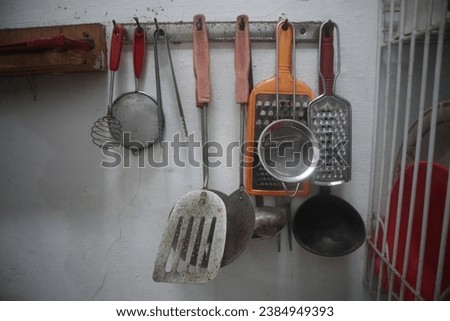 several cooking utensils hanging in the kitchen