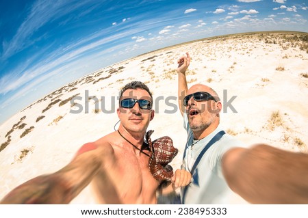 Adventurous best friends taking selfie at Etosha national park in Namibia - Adventure travel lifestyle enjoying moment and sharing happiness - Trip together around the world as alternative lifestyle