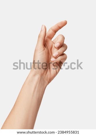 woman's hand pretending to pick something up Royalty-Free Stock Photo #2384955831