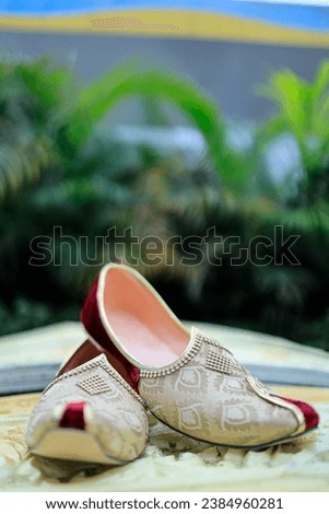 A closeup of royal wedding shoes or sandals for groom displayed on ground