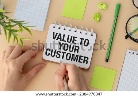 VALUE TO YOUR CUSTOMER, text on white paper on yellow background. business concept