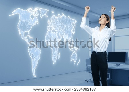 Attractive happy businesswoman celebrating success with creative digital map hologram on blurry office interior background