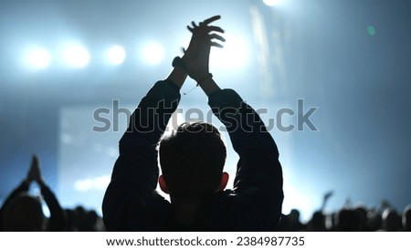 Cheer man fan hang out. Fun guy enjoy music concert. Epic neon glow light party. Cool dj live show. People clap night club hip hop fest. K pop event applaud. Joy rock roll rave. Crowd raise hand up. Royalty-Free Stock Photo #2384987735